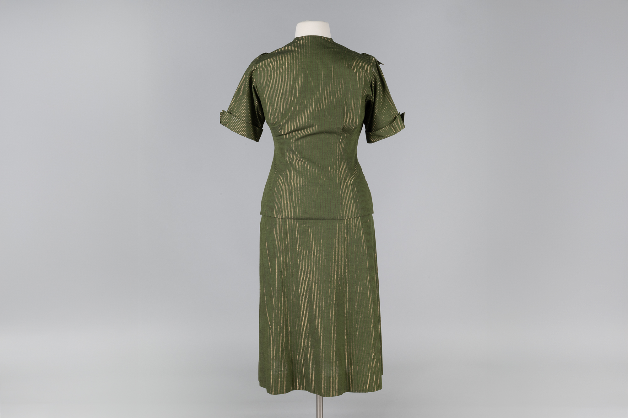 Image of Green skirt suit with gold stripes, ca. 1950